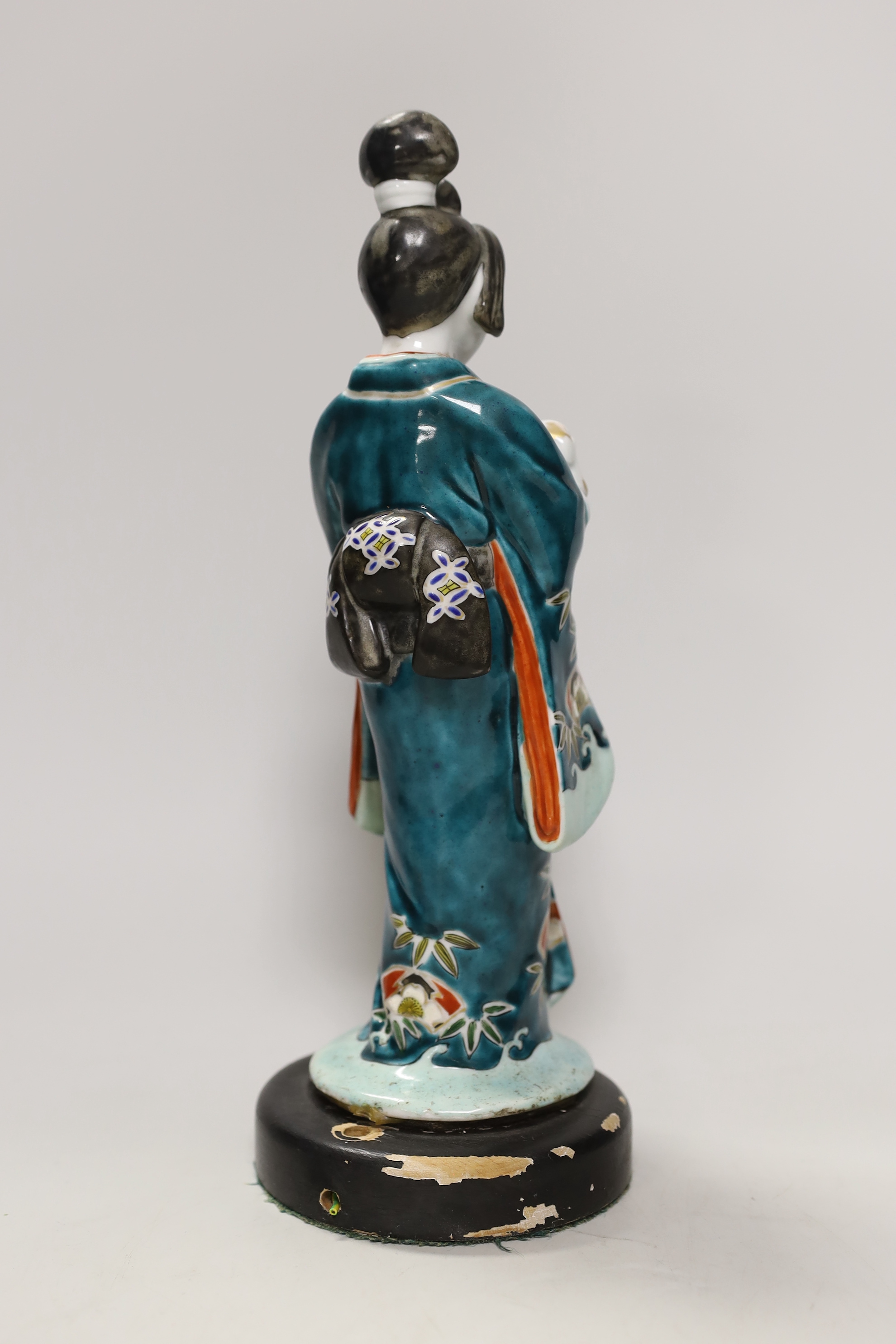 A Japanese Kutani figure of a Geisha and dog